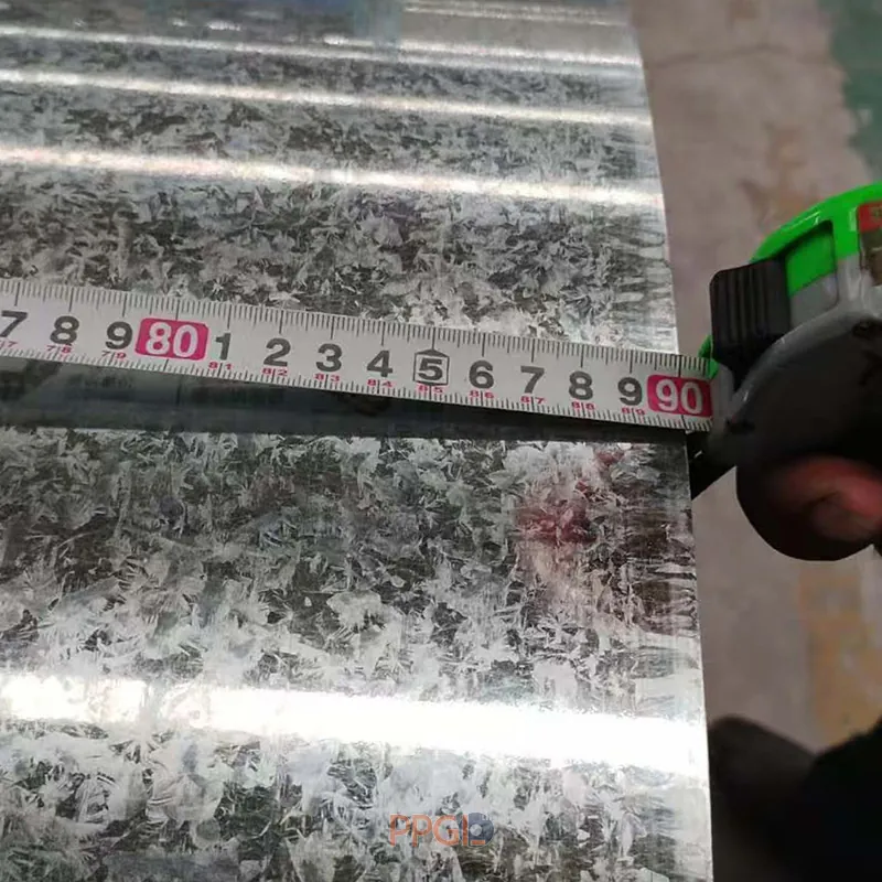 Normal spangle GI steel coil edge measurement with a green tape measure