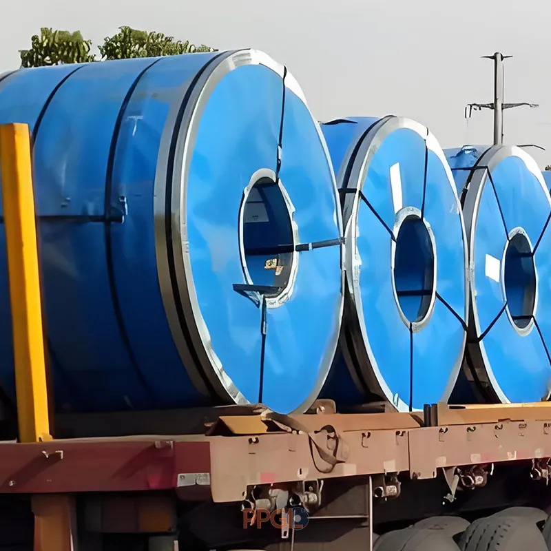 Blue packaged ppgi steel coils loaded on flatbed truck for transport