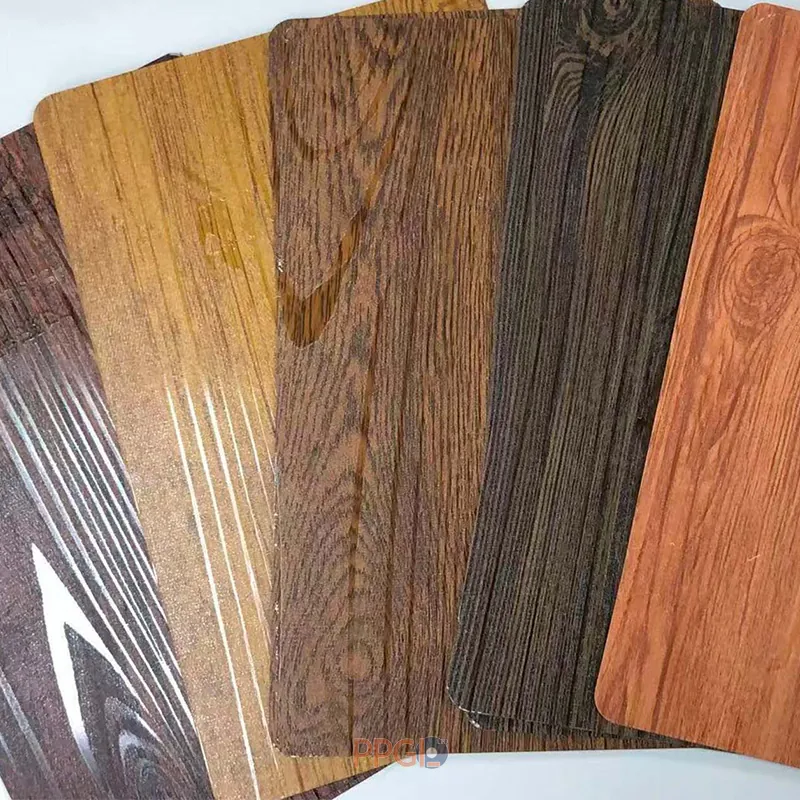 Printed and textured color coated steel coils with wood grain and matt wrinkle designs.