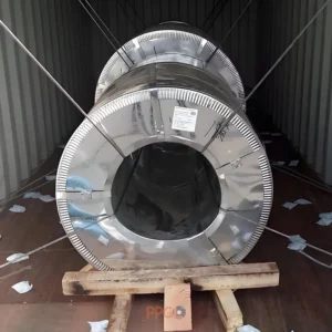 Steel coil loaded in a 20ft container secured with steel wire lashing and wooden chocks.